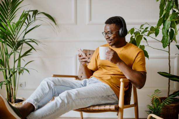 istock Young man listens to music while scrolls social media 1318116541