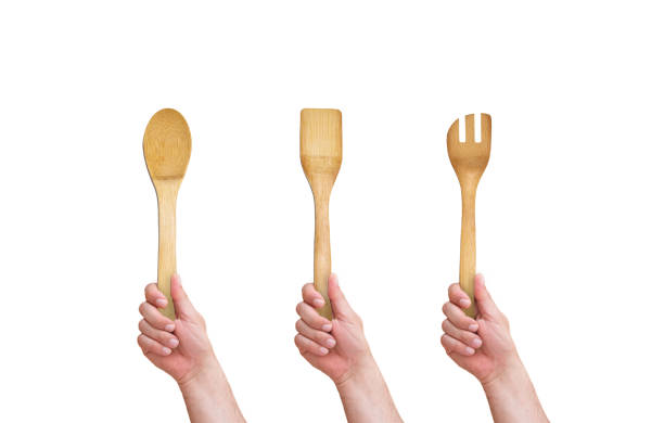 istock hand holding a wooden spoon 1318116632