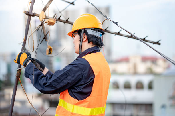 istock Asian worker repairing an old TV antenna on rooftop 1318116872