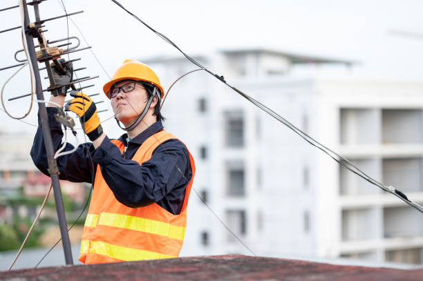 istock Asian worker repairing an old TV antenna on rooftop 1318116875