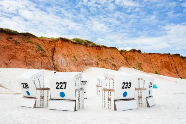 Beach - chairs on the island Sylt vertical. Germany. Red Cliffs.