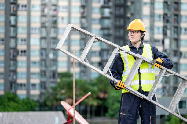 istock Maintenance worker man carrying aluminium ladder 1318117082