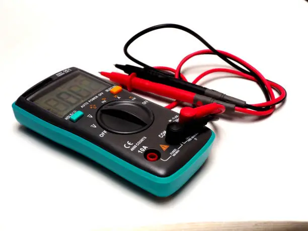 Picture of a digital multimeter, with red and black probe. Shoot on a white isolated background