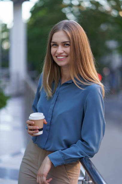 istock Charismatic woman drinking coffee to go at work 1318119780