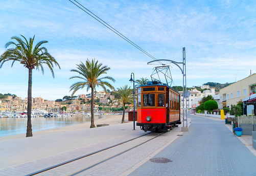 old tram of Port Soller beach with palmas, Mallorca at summer