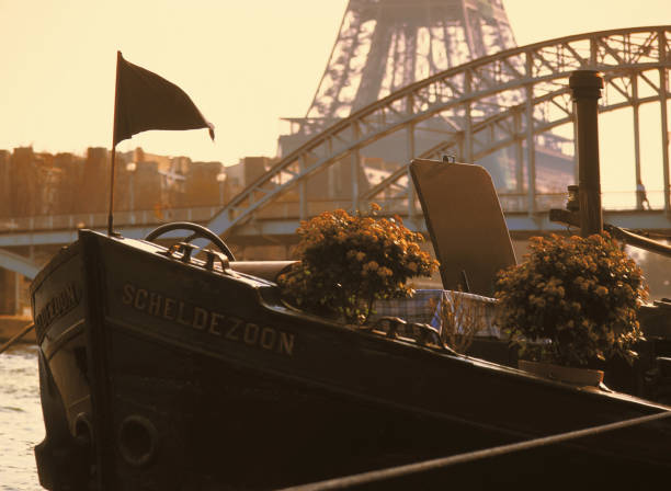 May 15th.2021. A view of the French City of Paris in the Springtime on a sunny day. A barge moored on the river seine with the eiffel tower behind. No people in the picture.