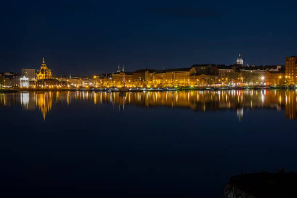 istock A beautiful panorama of downtown Helsinki waterfront with illuminated buildings casting reflections on the calm sea. 1318123603