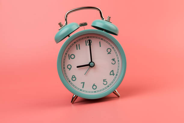 istock Old clock isolated on a pink background with space for text. Concept of time 1318124574