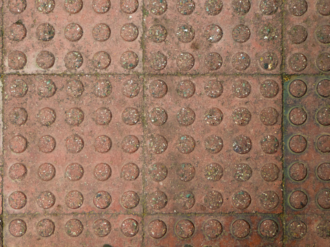 Marrakech green blue glazed tiles mosaic herringbone pattern on floor of Moroccan Riad