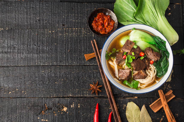 istock Spicy red soup beef noodle in a bowl on wooden table 1318126884