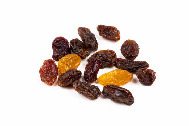 istock Raisins and golden raisins on white background. food, fruit, grape. 1318128710