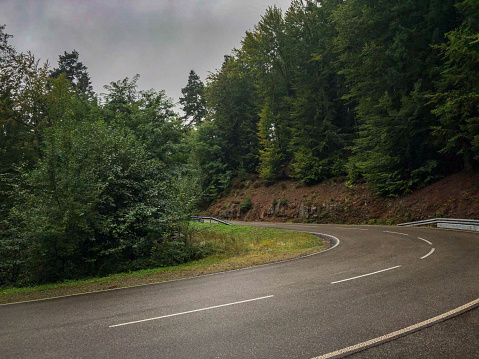 A very winding road through the Black Forest in Germany in the evening hours.