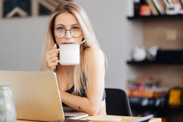 istock Young woman wearing glasses sit at desk watch webinar making notes 1318134845