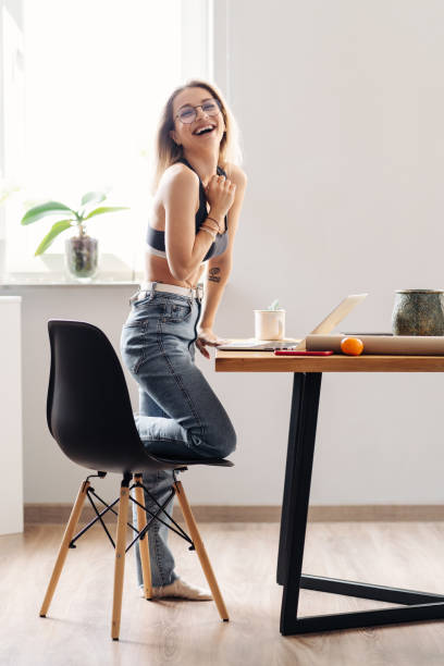 istock Modern girl relaxing at kitchen surfing internet 1318134892