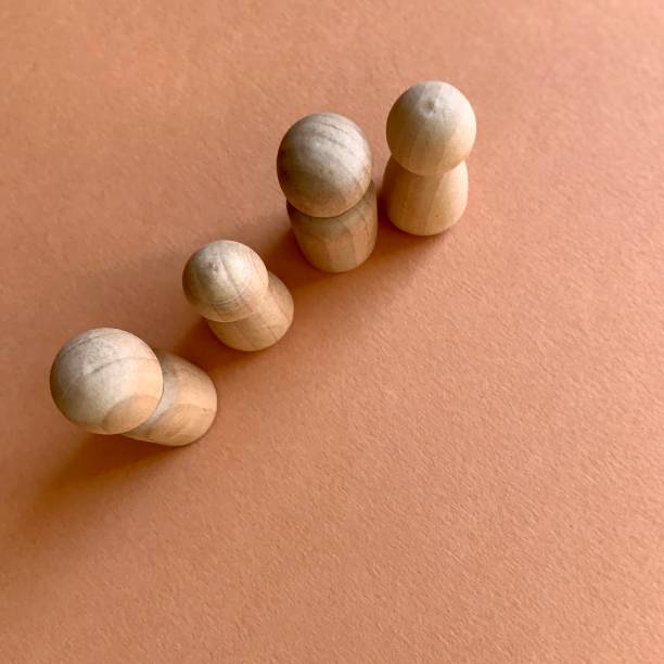 istock Wooden Peg People on Paper 1318136089