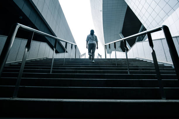 istock Young woman walking up stairs 1318137523