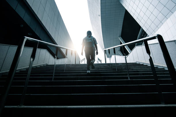 istock Young woman walking up stairs 1318137555