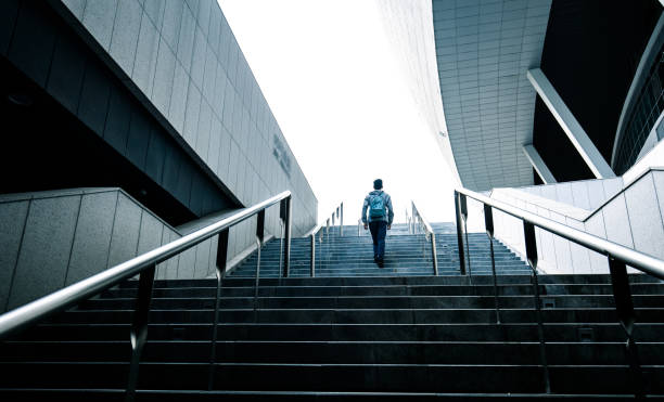 istock loneliness man walking up stairs 1318137587