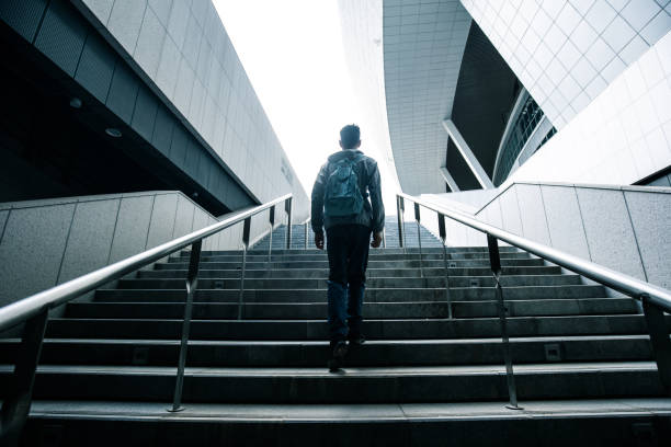 istock loneliness man walking up stairs 1318137588