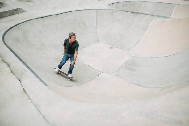 asiatische männliche skateboarding in einem skatepark - extreme skateboarding action balance motion stock-fotos und bilder