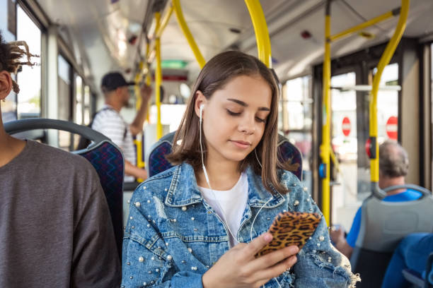 istock Girl using smart phone in public transport 1318140223