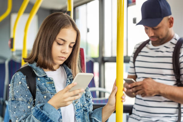 istock Girl using smart phone in public transport 1318140296