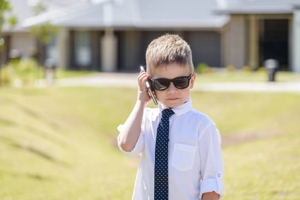 ładny australijski chłopiec za pomocą telefonu komórkowego - telephone child isolated on white elegance zdjęcia i obrazy z banku zdjęć