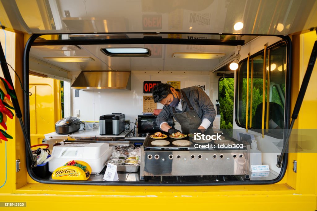 Mature man making tacos in his food truck Mature man making tacos in his food truck in preparation for opening Food Truck Stock Photo