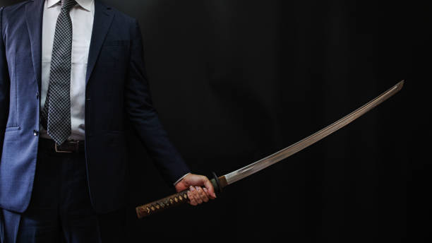 istock A man wearing suits and holding japanese sword 1318143916