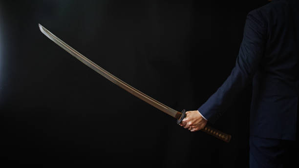 istock A man wearing suits and holding japanese sword 1318143934