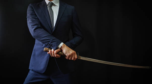 A man wearing suits and holding japanese sword stock photo