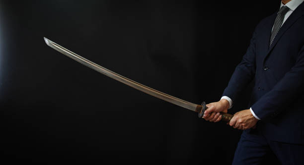 istock A man wearing suits and holding japanese sword 1318143963