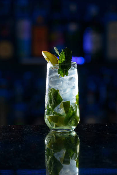 istock summer alcoholic cocktail mojito with rum, mint, lime and ice, bar tools, gray background, selective focus 1318145350
