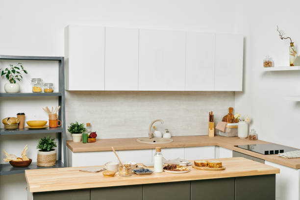 istock Interior of modern kitchen with white cabinets, table and other stuff 1318146248