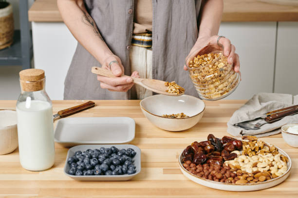 istock Hands of person preparing food by kitchen table 1318146265