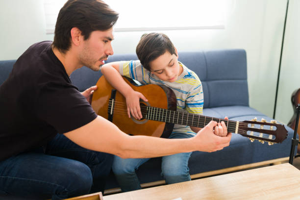 istock Learning the chords on the acoustic guitar 1318148610