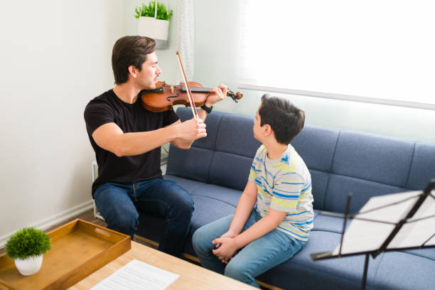 istock Talented boy paying attention to his violin instructor 1318148637