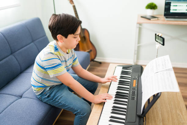 istock Side view of a kid learning a song on the piano 1318148828
