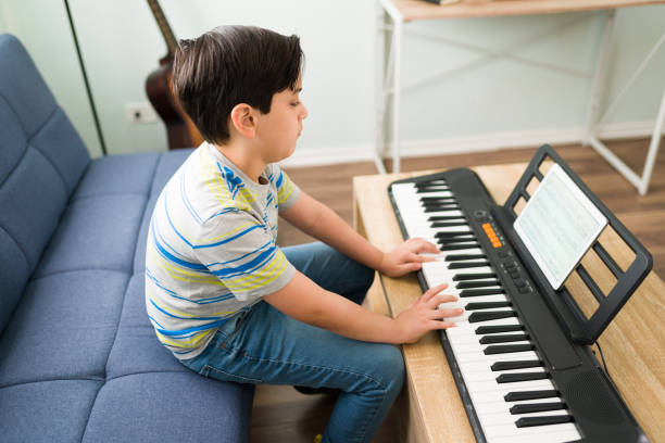 istock Cute child practicing a song on the piano 1318148853