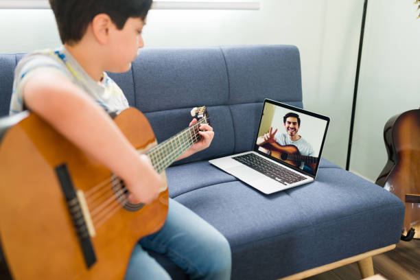 istock Playing the acoustic guitar with an instructor 1318148967