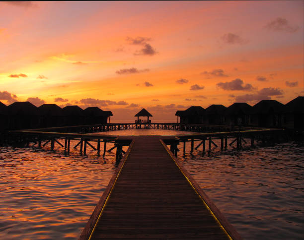 Orange pink and blue sunset over a beautiful beach resort in the Maldives