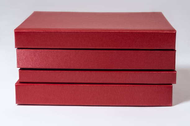 istock Stack of red hardcover books or reports on white background. 1318150023