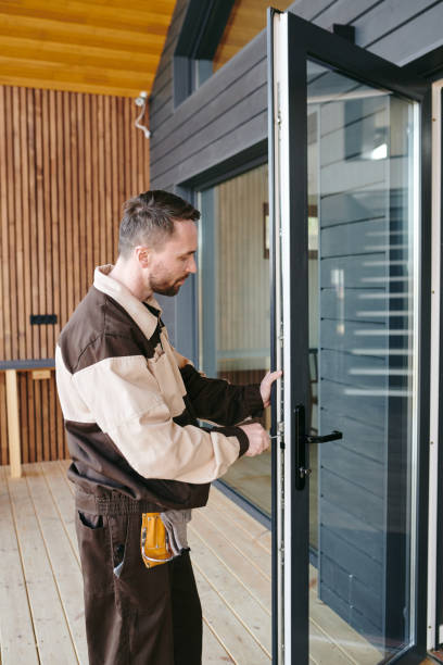 istock A man standing in front of a glass door while repairing lock 1318150142