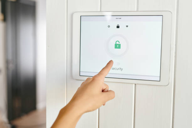 istock A hand pointing at panel of home security appliance 1318150282