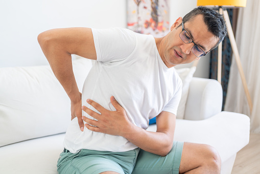 A man has chronic lower back pain and suffers from lower back pain