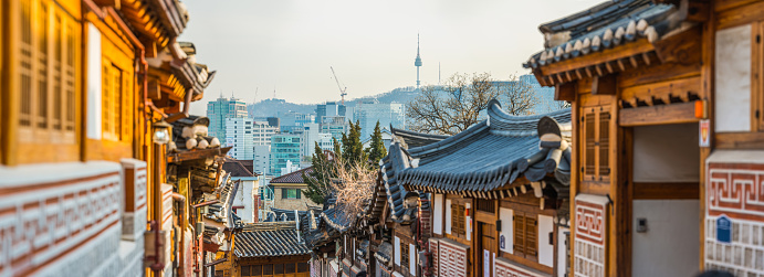 Old Seoul buildings with modern cityscape on the background, South Korea.