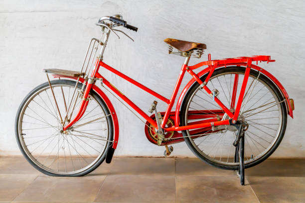 istock Old red bicycle stand on near wall. 1318153489