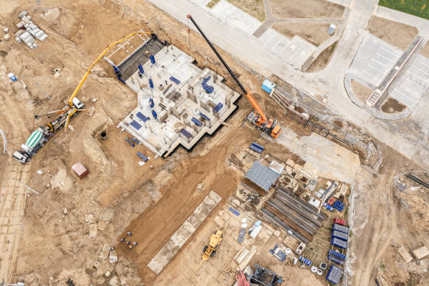 istock construction site, aerial view. building concrete foundation for new multistory house - pouring a wet concrete into floor slab. 1318157981