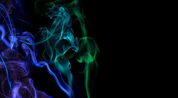 istock Colored smoke on black background. Blue and Green colors. 1318158841