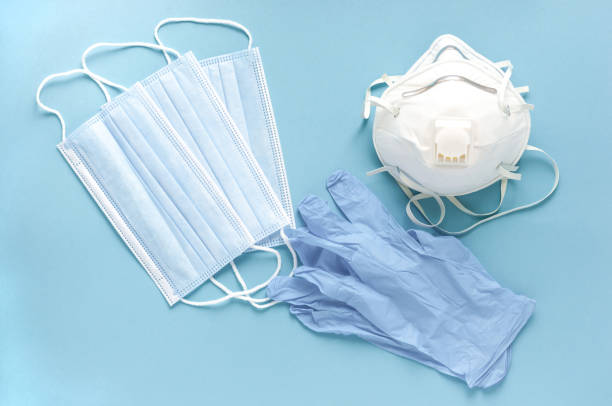 istock Masks, gloves, respirators on a blue background. 1318159139